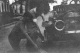 Hildred and brother changing tire on Brush Runabout car (1912)