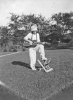 Hildred playing guitar in yard (1914)