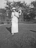 Hildred with cheerleader flag in yard (1914)