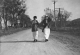 Two Women Walking on Road