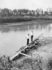 Two Men Standing on Downed Tree in Mississippi Slough